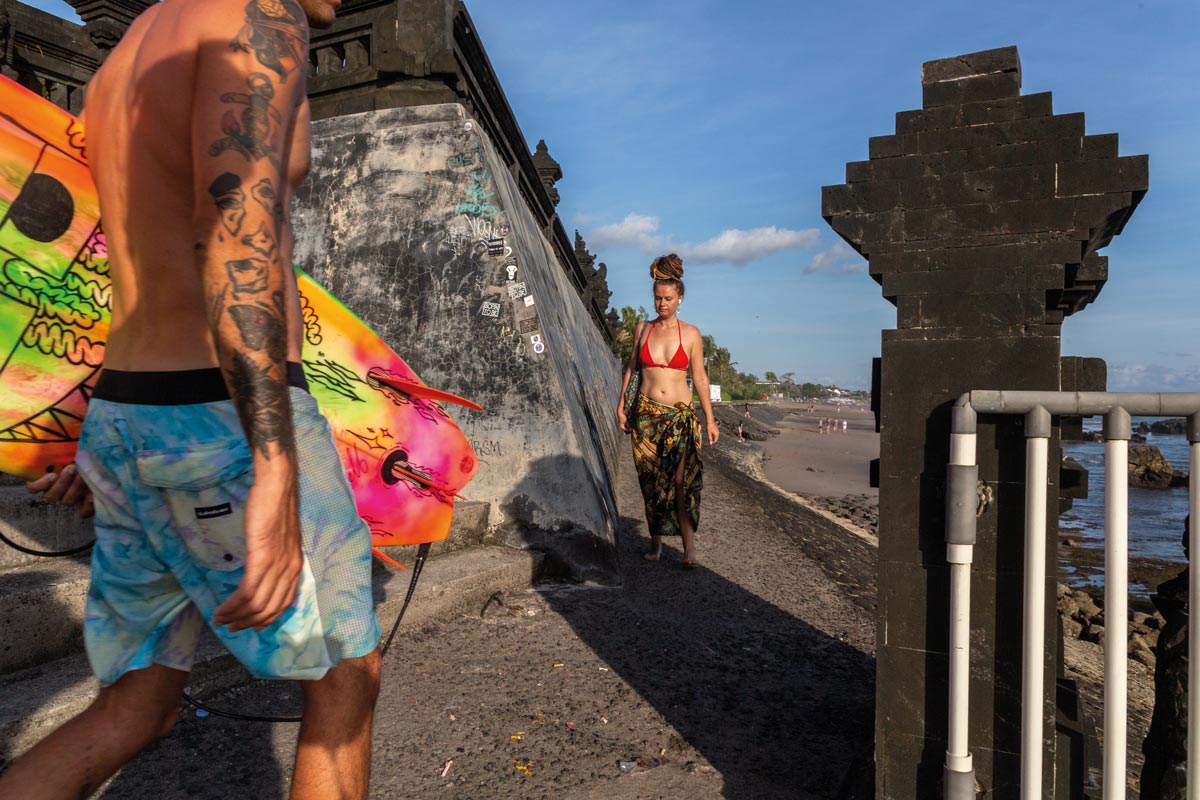 Klasszikus jelenet a Canggu városrészben – Fehér emberek sétálgatnak szörfdeszkával, „specialty kávéval”. Itt nem mindenki turista, sokan életvitelszerűen tartózkodnak a szigeten, digitális nomádként távmunkával teremtve meg ennek lehetőségét Fotó: Kocsány Kornél